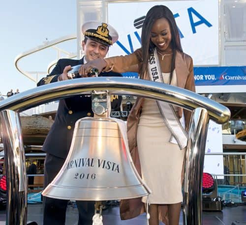 Carnival Vista captain Luigi De Angelis, left, and Miss USA Deshauna Barber, right, pour champagne over a ship's bell to name the new Carnival Vosta Friday , Nov. 4, 2016, in New York City. Barber is the ship's godmother and presided over naming ceremonies. The 1,062-foot-long Carnival Vista is scheduled to sail on 11-day voyages from New York before launching year-round six- and eight-day Caribbean cruises from Miami beginning Nov. 27. FOR EDITORIAL USE ONLY (Andy Newman/Carnival Cruise Line/HO)